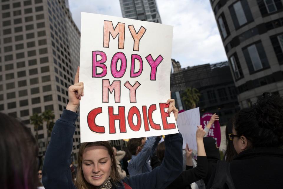 A protester holds aloft a ‘my body, my choice’ placard in a 2021 demonstration in Alabama. <a href="https://www.gettyimages.com/detail/news-photo/an-activist-seen-holding-a-placard-that-says-my-body-my-news-photo/1145542984?adppopup=true" rel="nofollow noopener" target="_blank" data-ylk="slk:Ronen Tivony/SOPA Images/LightRocket via Getty Images;elm:context_link;itc:0;sec:content-canvas" class="link ">Ronen Tivony/SOPA Images/LightRocket via Getty Images</a>