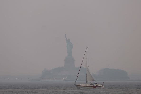 NEW YORK, NEW YORK - JUNE 06: The Statue of Liberty stands shrouded in a reddish haze as a result of Canadian wildfires on June 06, 2023 in New York City. Over 100 wildfires are burning in the Canadian province of Nova Scotia and Quebec resulting in air quality health alerts for the Adirondacks, Eastern Lake Ontario, Central New York and Western New York.  (Photo by Spencer Platt/Getty Images)