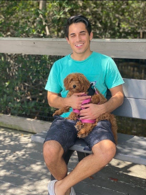 Robert Garon, 23, poses with his puppy, Buzz Lightyear, a 5-month-old Goldendoodle who died July 29 due to possible head trauma.
