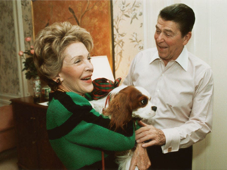 President Ronald and first lady Nancy Reagan hold their dog Rex.