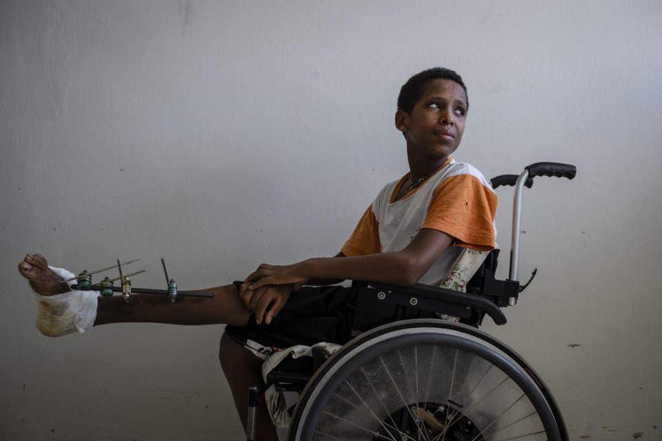 Desalegn Gebreselassie, 15, sits in his wheelchair as he recovers at the Ayder Referral Hospital in Mekele, in the Tigray region of northern Ethiopia, on Thursday, May 6, 2021. The teenager's foot was injured when a grenade exploded in his town of Edaga Hamus. (AP Photo/Ben Curtis)