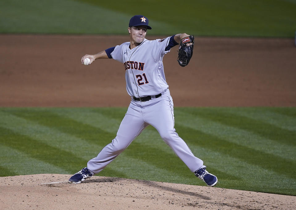 Houston Astros pitcher Zack Greinke (21) throws against the Oakland Athletics in the first inning of an opening day baseball game Oakland, Calif., Thursday, April 1, 2021. (AP Photo/Tony Avelar)