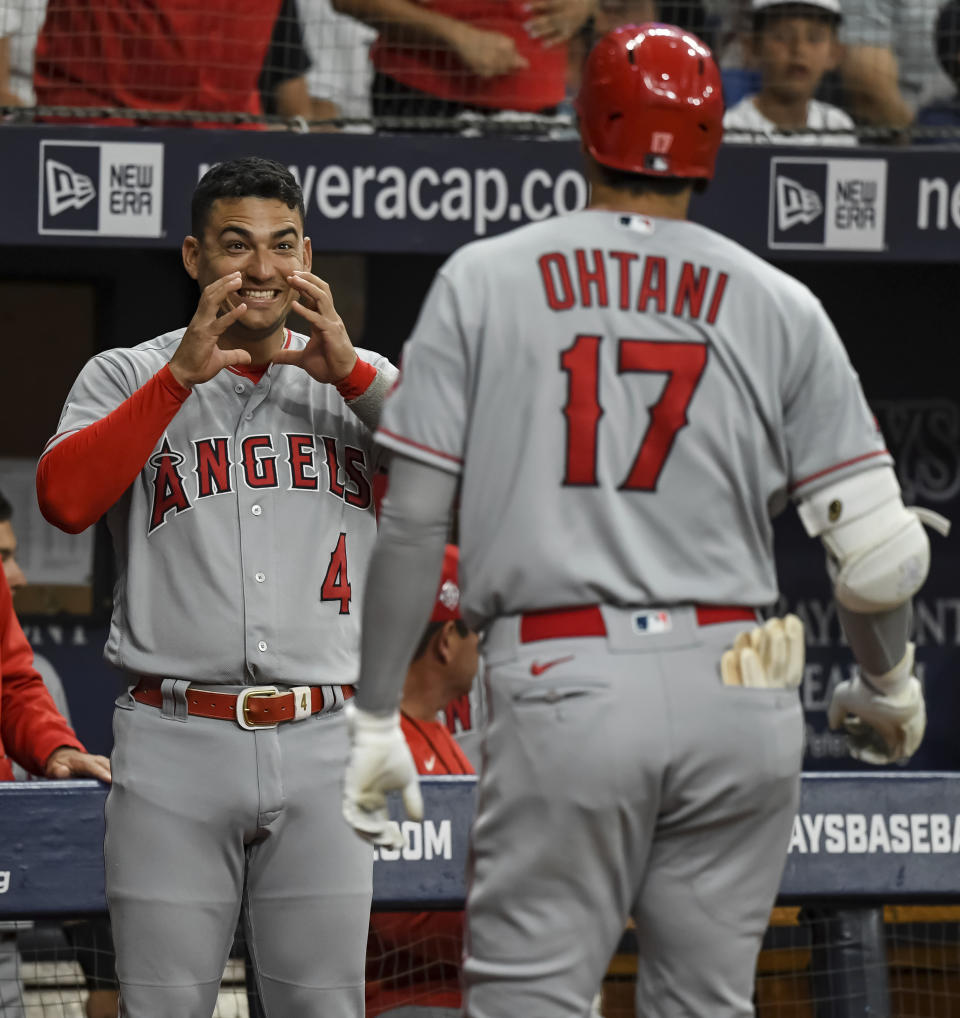 Los Angeles Angels' Jose Iglesias (4) greets Shohei Ohtani at the dugout after Ohtani's solo home run off Tampa Bay Rays' Andrew Kittredge during the first inning of a baseball game Friday, June 25, 2021, in St. Petersburg, Fla. (AP Photo/Steve Nesius)
