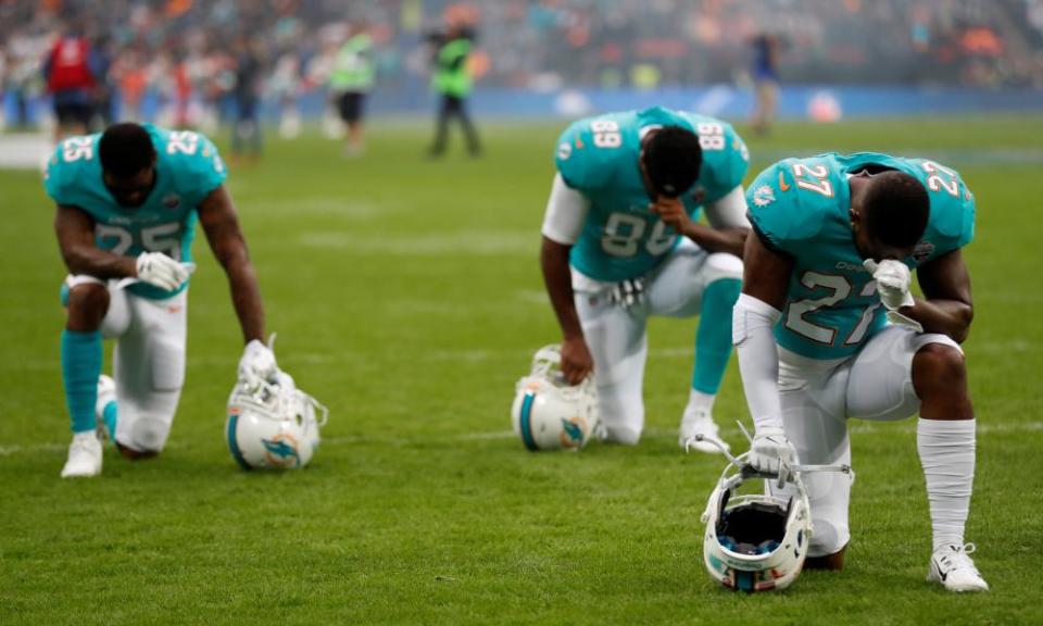 Miami Dolphins players kneel before a match at Wembley stadium in London on 1 October 2017. Trump’s response to the NFL anthem protests against racial injustice was: ‘Get that son of a bitch of the field.’