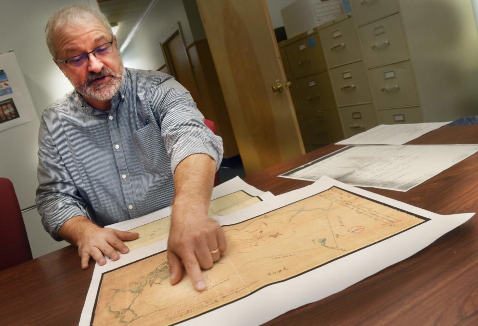 In this 2018 file photo, York Town Manager Steve Burns points out an area on an old map showing a discrepancy in the border between York and its municipal neighbor Kittery, Maine.