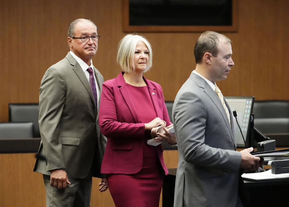 Michael Ward, left, and his wife and former Arizona Republican Party Chairperson Kelli Ward, center, appear with their attorney Brad Miller, right, for their arraignment in Maricopa County Superior Court, Tuesday, May 21, 2024, in Phoenix. Arizona is the fourth state where allies of former President Donald Trump have been charged with using false or unproven claims about voter fraud related to the election. (Rob Schumacher/The Arizona Republic via AP, Pool)