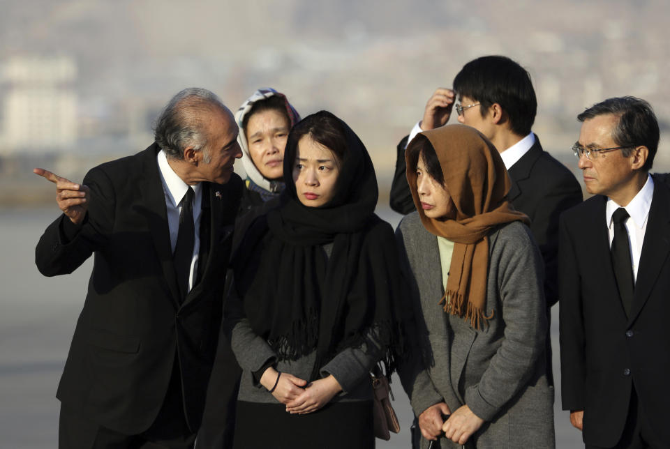 From right, Naoko Nakamura, wife, and, Akiko Nakamura, daughter of slain Japanese physician Tetsu Nakamura stand during a ceremony before transporting his body to his homeland, at the Hamid Karzai International Airport in Kabul, Afghanistan, Saturday, Dec. 7, 2019. Nakamura was killed earlier this week in a roadside shooting in eastern Afghanistan. (AP Photo/Rahmat Gul)