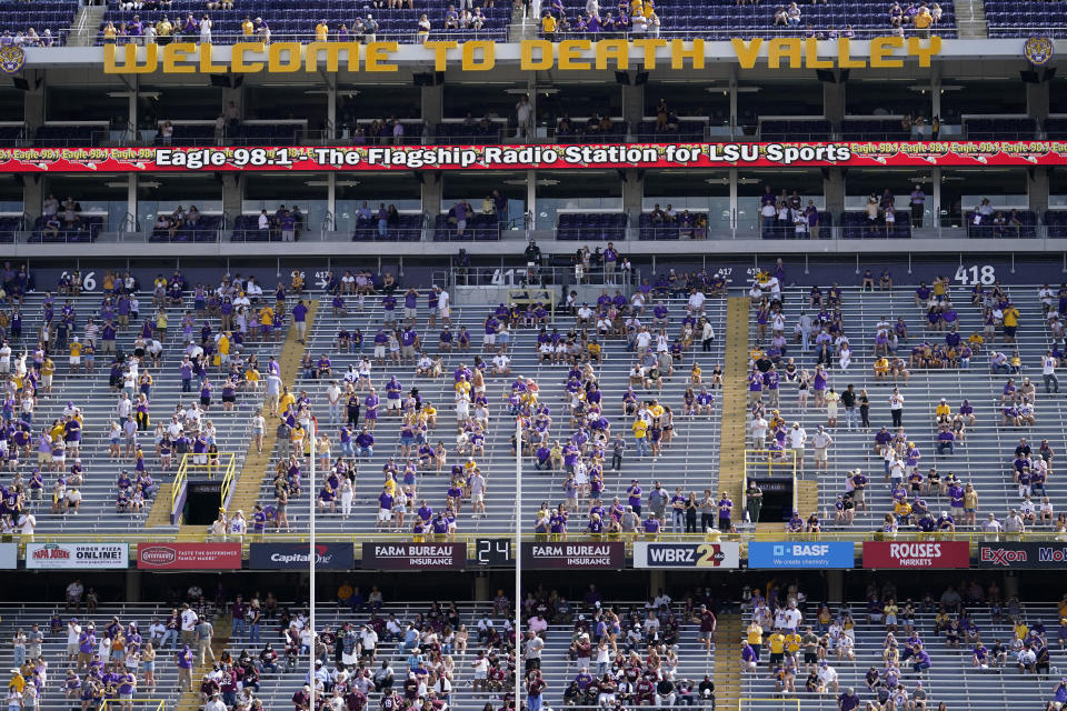 A limited number of fans, seated according to COVID-19 restrictions requiring social distancing and masks, watch in the first half an NCAA college football game between LSU and Mississippi State in Baton Rouge, La., Saturday, Sept. 26, 2020. Mississippi State won 44-34. (AP Photo/Gerald Herbert)