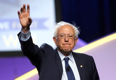 Democratic U.S. Presidential candidate Senator Bernie Sanders waves to the audience during the Presidential candidate forum at the annual convention of the National Association for the Advancement of Colored People (NAACP), in Detroit