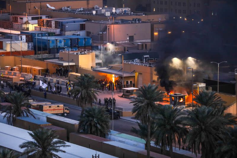 Protestors set fire to an entry control point at the U.S. Embassy in Baghdad