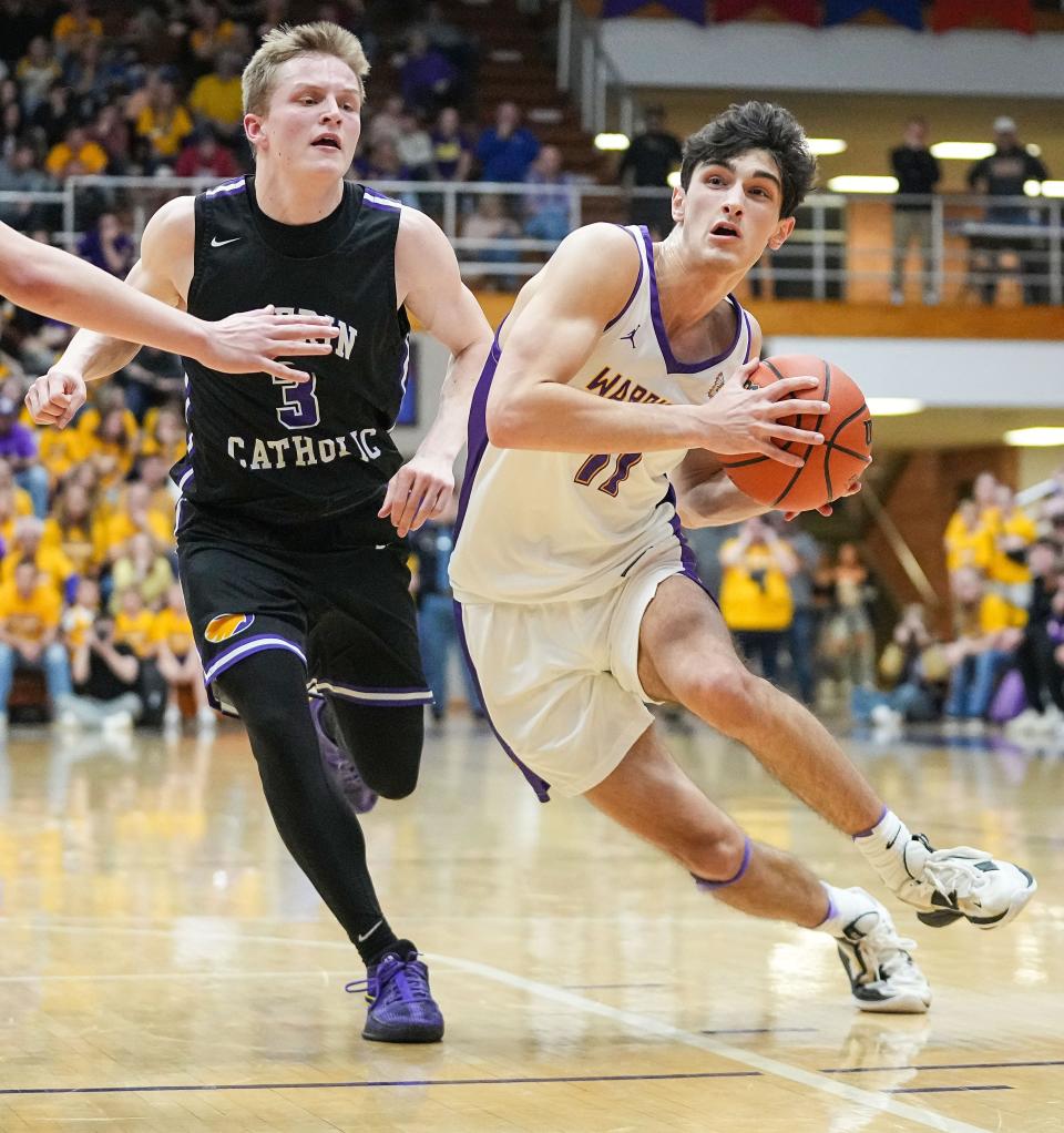 Scottsburg's Jack Miller (11) rushes up the court against Guerin Catholic Golden Eagles Robert Sorensen (3) on Saturday, March 16, 2024, during the IHSAA Class 3A semi-state finals at Seymour High School in Seymour. Scottsburg defeated the Guerin Catholic Golden Eagles, 74-50.