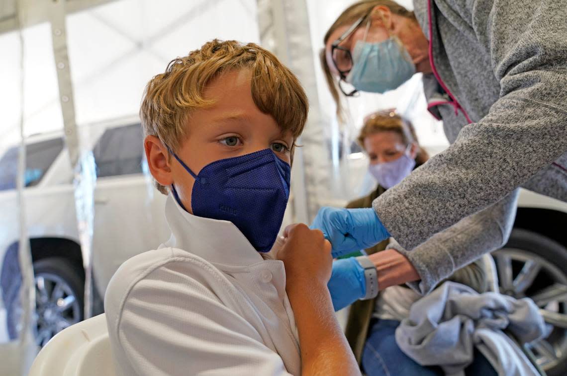 Max Betasso, 8, receives the Pfizer COVID-19 vaccine for children five to 12 years from Dallas County Health and Human Services nurse Shari Yarto at a vaccination site in Mesquite, Texas, Thursday, Nov. 4, 2021. (AP Photo/LM Otero)