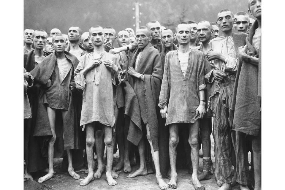 FILE - Starved prisoner's, nearly dead from hunger, at one of the largest Nazi Concentration camps at Evensee Austria, in the Austrian Alps, May 7, 1945. Many were starving to death and inmates were dying at the rate of 2,000 per week. The camp was reputedly used for 'Scientific' experiments. It was liberated by the 80th Division, U.S. Third Army. (AP Photo, File)