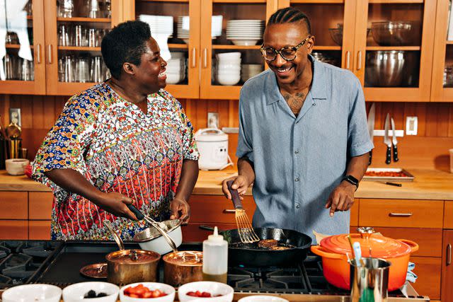 <p>JosÃ© Mandojana</p> Gourdet and his friend chef Elsy Dinvil share a laugh while preparing Akra