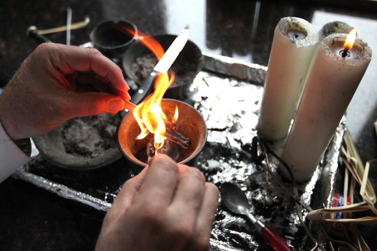 Donald Harris, the business manager for the Corpus Christi Cathedral, demonstrates how ashes are made in February 2013 that are used in Ash Wednesday services. Ashes are placed on the forehead of believers at the beginning of Lent, which is Wednesday. Lent continues for 40 days and is in preparation for Easter.