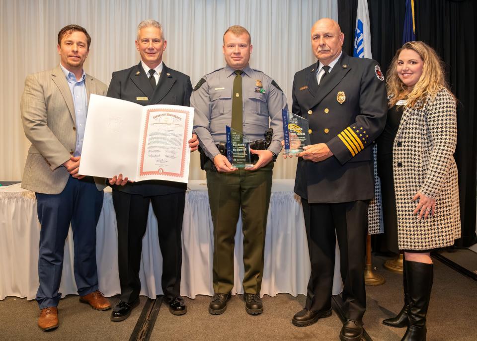 Corey Parker, left, stands with Monroe Charter Township Fire Chief Mark Cherney, Conservation Officer Nic Ingersoll, Assistant Chief Mike Broman and Ashleigh Glass. Ingersoll and Capt. Dave Nadeau were honored with the Fire Hero Award. Cherney and Broman accepted the award on behalf of Nadeau, who was unable to attend.