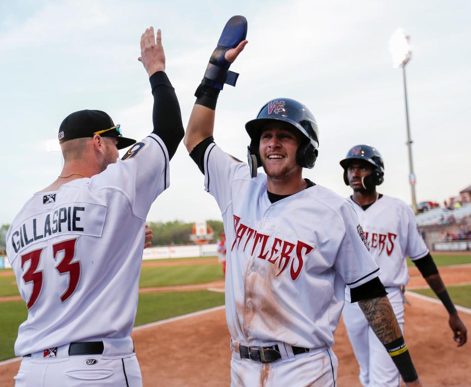 Wisconsin Timber Rattlers second baseman Brice Turang (2) high fives pitcher Logan Gillaspie (33) in the MiLB game between the Peoria Chiefs and Wisconsin Timber Rattlers at Neuroscience Group Field at Fox Cities Stadium on May 22, 2019. The Timber Rattlers won 7-2.