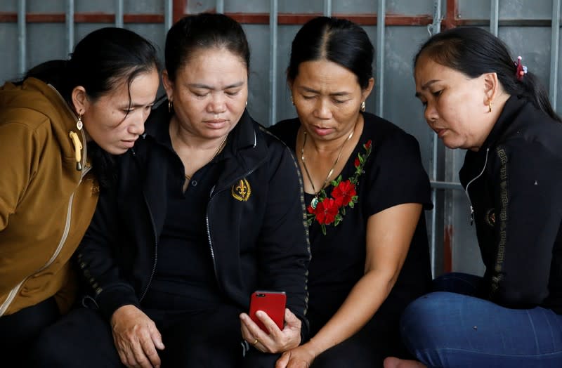 Relatives of Anna Bui Thi Nhung, a Vietnamese suspected victim in a truck container in UK, read news about her at her home in Nghe An province