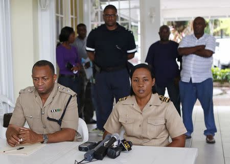 Jamaica Coast Guard Lieutenant Commander Judy-Ann Neil (R) and Senior Police Superintendent Terrence Bent give a news conference on the status of their search for a small U.S. private plane with an unresponsive pilot that crashed off the east coast of Jamaica, at the Errol Flynn Marina in Port Antonio September 6, 2014. REUTERS/Gilbert Bellamy