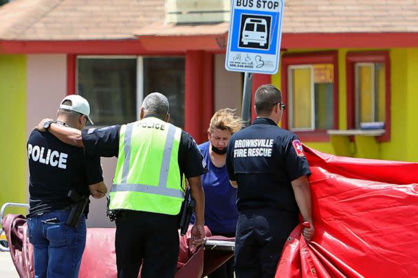 PHOTO: A police officer is consoled after after a deadly incident where a car ran into pedestrians near Ozanam Center, a shelter for migrants and homeless, in Brownsville, Texas, May 7, 2023. (John Faulk/Reuters)