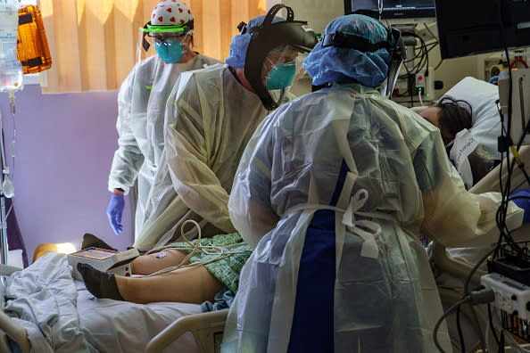 Dr Dennis Amundson works with his colleagues to intubate a patient with COVID-19 symptoms, who just arrived at the ICU at Scripps Mercy Hospital in Chula Vista, California.