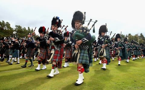 Pipers march during the Braemar Highland Games - Credit: Chris Jackson