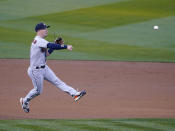 Houston Astros third baseman Alex Bregman (2) throws to first base for an out against Oakland Athletics' Mark Canha in the first inning of an opening day baseball game Oakland, Calif., Thursday, April 1, 2021. (AP Photo/Tony Avelar)