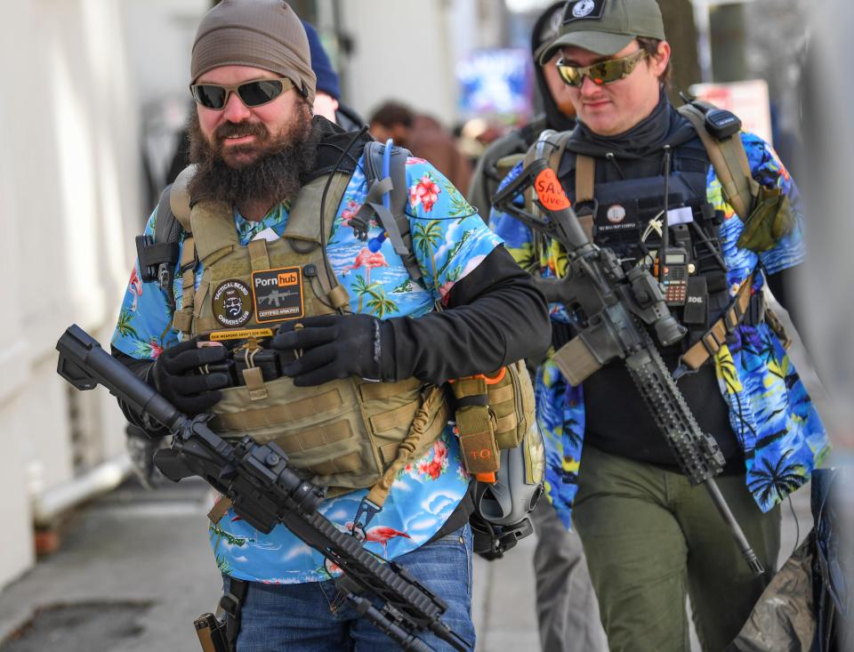 Gun rights advocates and unauthorized militia members gather in Virginia's capitol to protest potential gun control bills. A circuit court judge upheld Gov. Ralph Northam's temporary ban on firearms in Capitol Square.