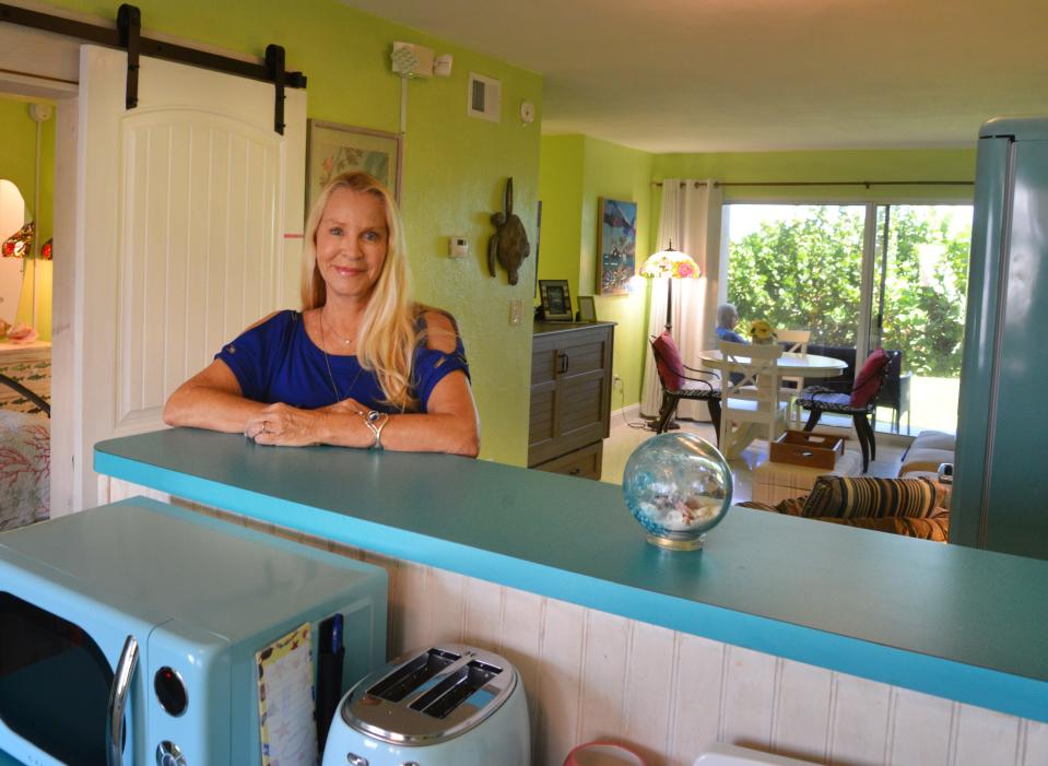 Pamela Durkin, broker/owner of Coconut Properties Florida Real Estate in Cocoa Beach, stands inside one of the retro beach Airbnbs near her office.