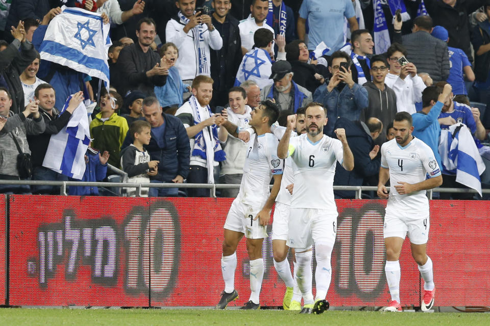 Israel's Eran Zahavi and teammates celebrate after scoring during the Euro 2020 group G qualifying soccer match between Austria and Israel, in Haifa, Israel, Sunday, March 24, 2019. (AP Photo/Ariel Schalit)