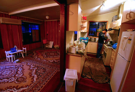 Ali Rasooli, a refugee from Afghanistan, makes tea in the kitchen of a house he rents with other refugees, in the western Sydney suburb of Guildford, Australia, July 17, 2016. REUTERS/David Gray