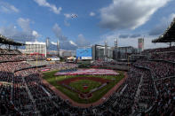 F-16s fly over during the national anthem before a baseball game between the Atlanta Braves and the St. Louis Cardinals, Monday, July 4, 2022, in Atlanta. (AP Photo/Butch Dill)