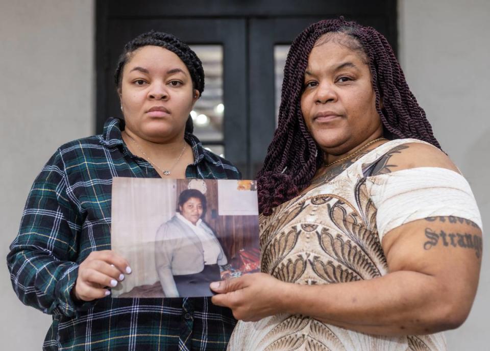 Caption: Colett Boston, left, and Everlean Boston hold a photograph of their mother, Mae Evelyn Boston, in Oxford, Mississippi. In 1987, when Colett was a newborn and Everlean was 12 years old, their mother died in the Lafayette County jail as she waited for a mental health evaluation. (Eric J. Shelton/Mississippi Today)