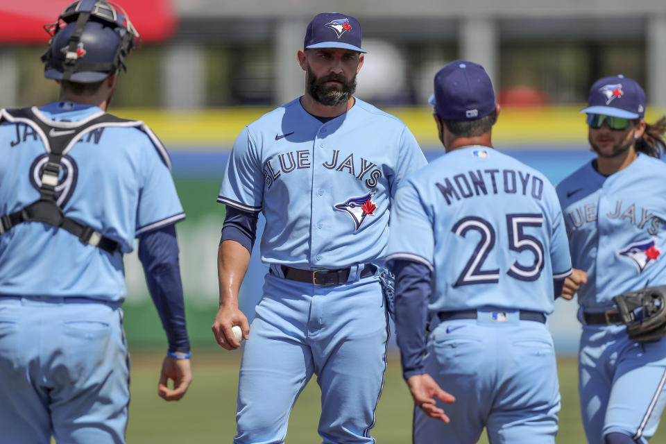 Toronto Blue Jays relief pitcher Tyler Chatwood, center, waits for manager Charlie Montoyo to remove him as catcher Danny Jansen (9) and Bo Bichette join them during the ninth inning of a baseball game against the Tampa Bay Rays Sunday, May 23, 2021, in Dunedin, Fla. (AP Photo/Mike Carlson)