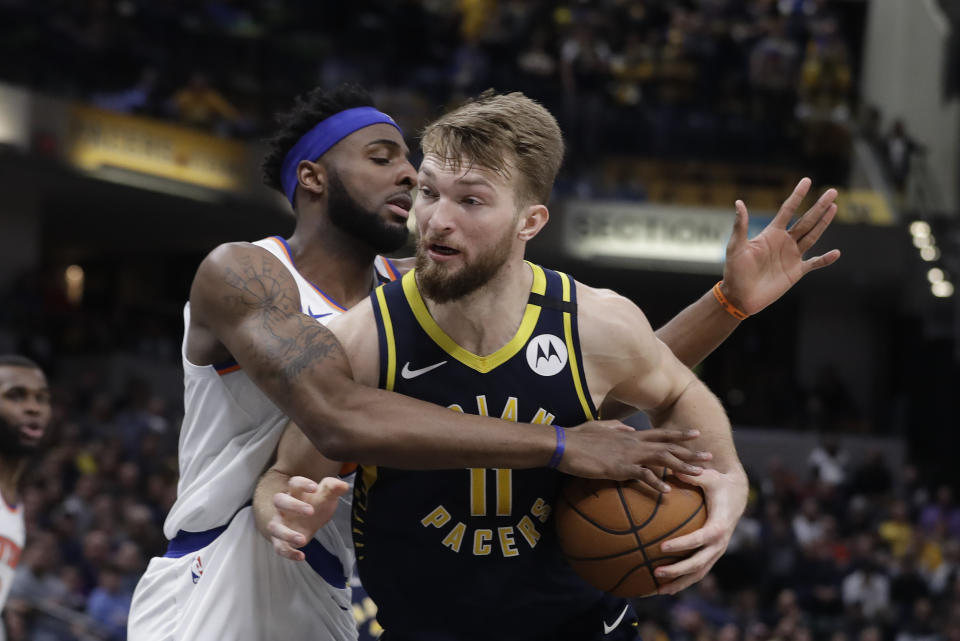 Indiana Pacers' Domantas Sabonis (11) goes to the basket against New York Knicks' Mitchell Robinson during the second half of an NBA basketball game Saturday, Feb. 1, 2020, in Indianapolis. New York won 92-85. (AP Photo/Darron Cummings)