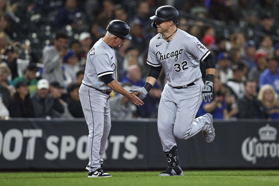 Chicago White Sox's Gavin Sheets is greeted by third base coach Eddie Rodriguez after hitting a solo home run off Seattle Mariners starting pitcher Bryan Woo during the fifth inning of a baseball game Friday, June 16, 2023, in Seattle. (AP Photo/John Froschauer)