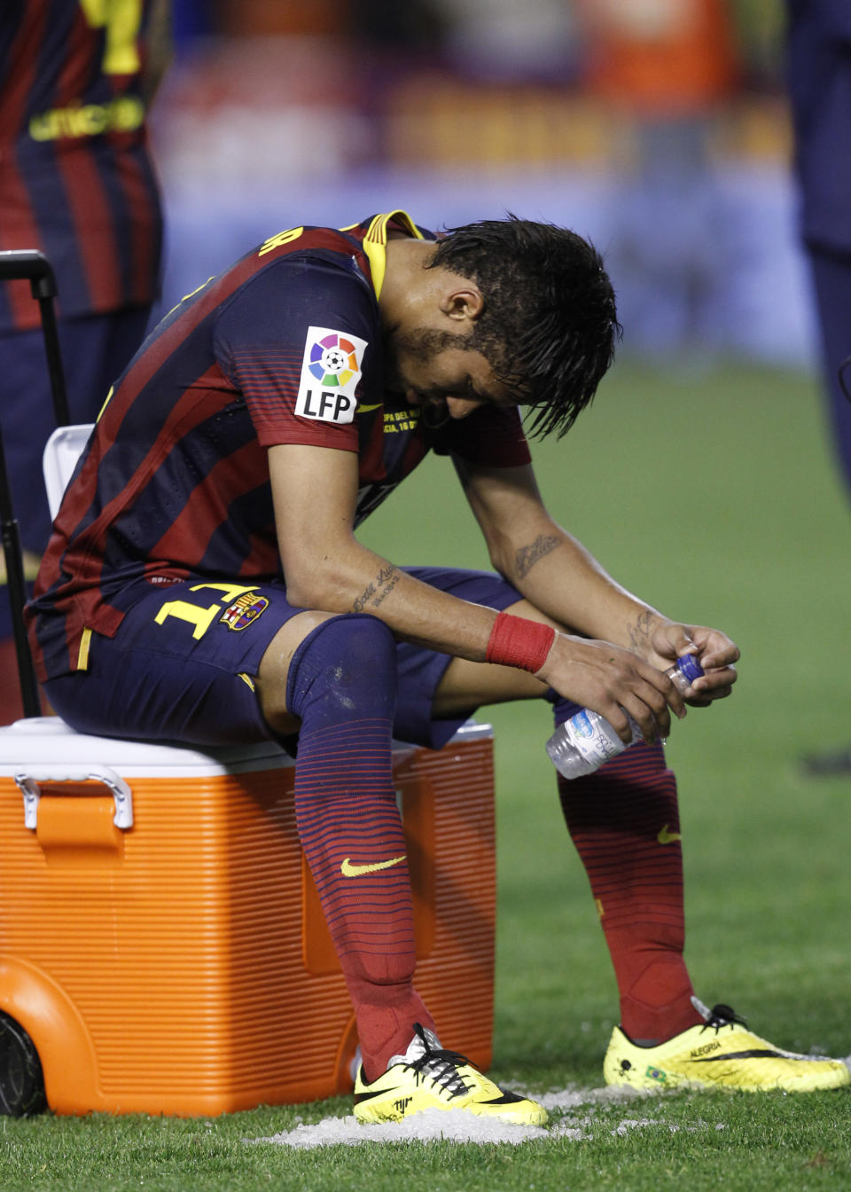 Barcelona's Neymar sits after Real Madrid won the final of the Copa del Rey between FC Barcelona and Real Madrid at the Mestalla stadium in Valencia, Spain, Wednesday, April 16, 2014. (AP Photo/Alberto Saiz)