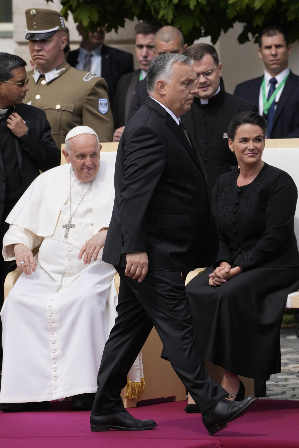 Hungary Prime Minister Viktor Orban, center, walks past Pope Francis and Hungary President Katalin Novák in the square of "Sándor" Palace in Budapest, Friday, April 28, 2023. The Pontiff is in Hungary for a three-day pastoral visit. (AP Photo/Andrew Medichini)