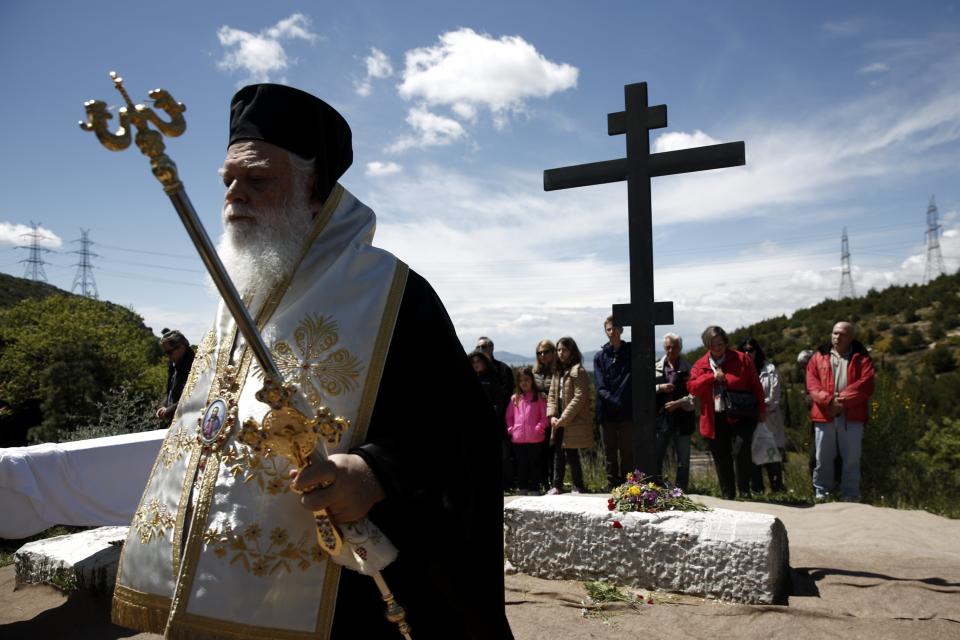 An Orthodox Metropolitan follows a procession during a re-enactment of Jesus Christ's Deposition from the Cross on Good Friday at Penteli monastery, north of Athens