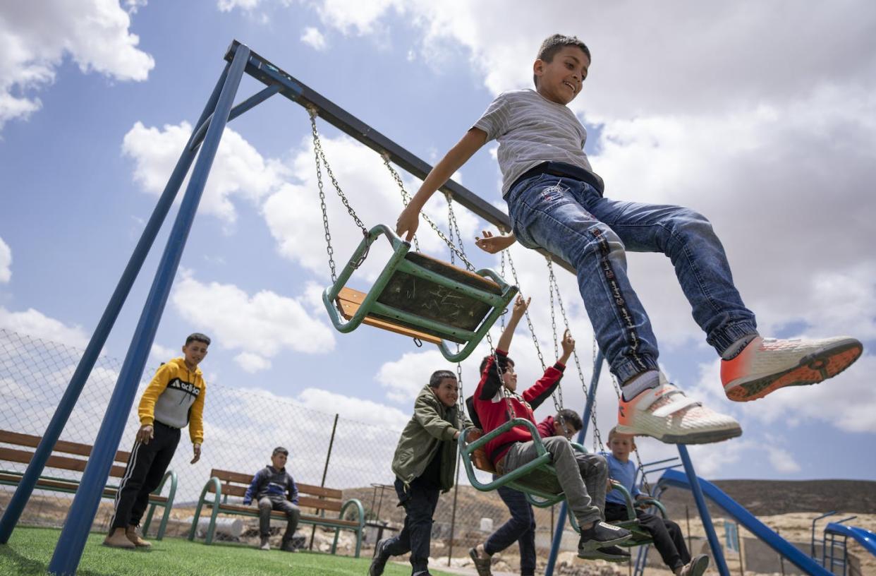 Palestinian children play at an entertainment facility in the West Bank community of Jinba, Masafer Yatta, in May 2022. (AP Photo/Nasser Nasser)