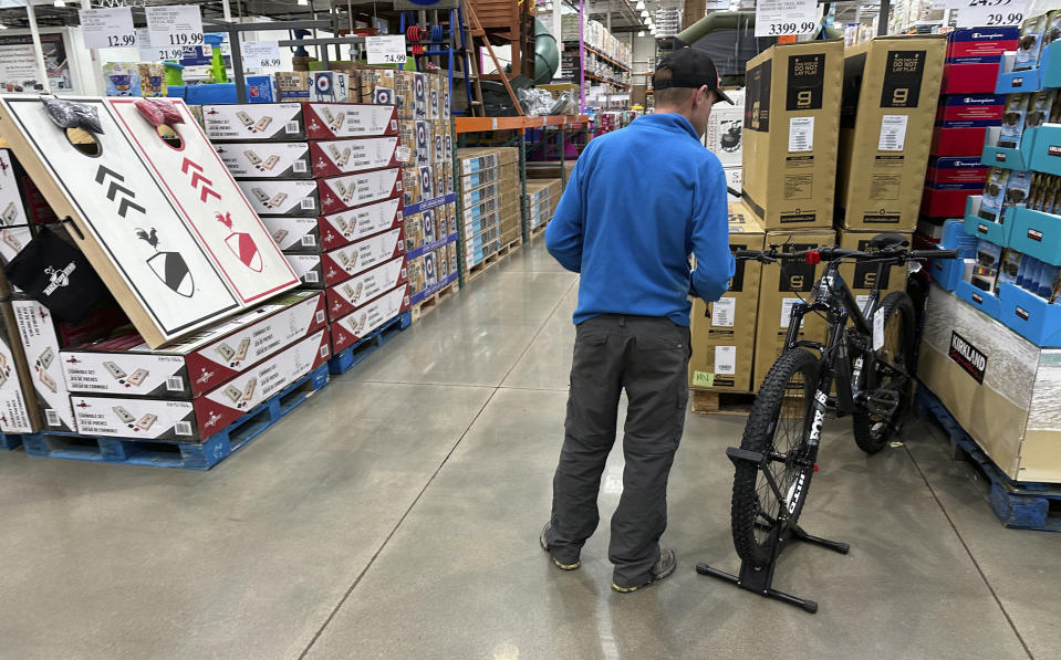 File - A shopper peruses a mountain bicycle on display in a Costco warehouse Wednesday, May 10, 2023, in Sheridan, Colo. On Tuesday, the Commerce Department releases U.S. retail sales data for April. Analysts who follow the retail industry estimate that the resumption of student loan payments could trim consumer spending by $14 billion a month or $305 per borrower.(AP Photo/David Zalubowski, File)