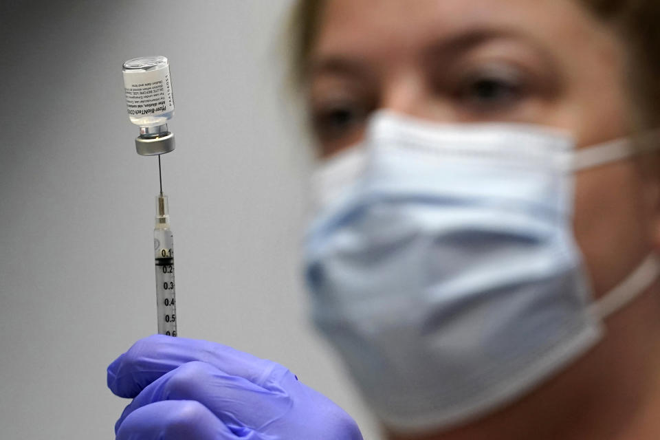 FILE - In this March 2, 2021, file photo, Hollie Maloney, a pharmacy technician, loads a syringe with Pfizer's COVID-19 vaccine at the Portland Expo in Portland, Maine. An influential federal advisory panel overwhelmingly rejected a plan Friday, Sept. 17, to offer Pfizer booster shots against COVID-19 to most Americans, dealing a heavy blow to the Biden administration’s effort to shore up people’s protection amid the highly contagious delta variant. (AP Photo/Robert F. Bukaty, File)