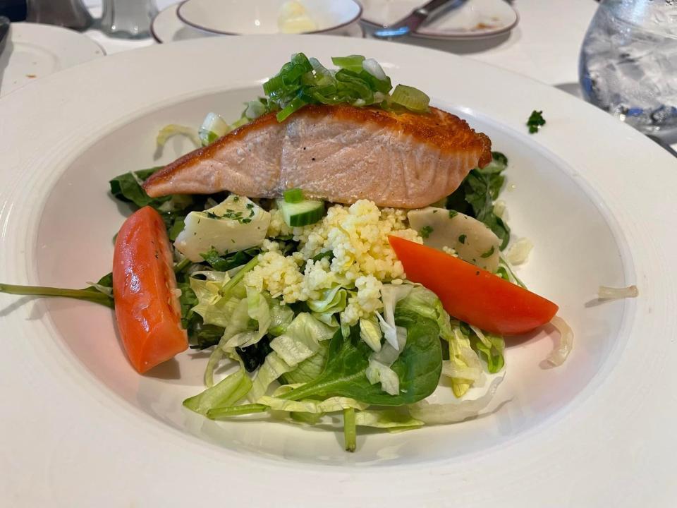 plate of salmon and vegetables on a disney cruise