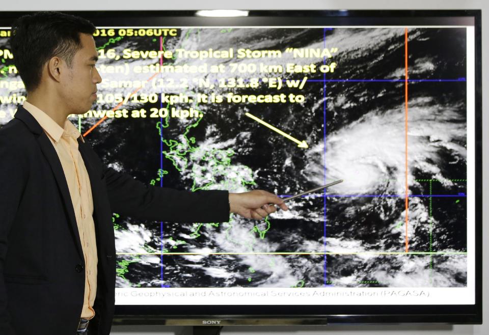 Weather specialist Benison Estareja shows the track of Tropical Storm Nock-Ten during a press conference in Quezon city, north of Manila, Philippines on Friday, Dec. 23, 2016. A severe tropical storm has gained strength as it moves closer to the Philippines and may intensify further into a typhoon, bringing moderate to heavy rains and blustery weather on Christmas Day, the biggest holiday in the predominantly Roman Catholic nation, weather forecasters said. (AP Photo/Aaron Favila)