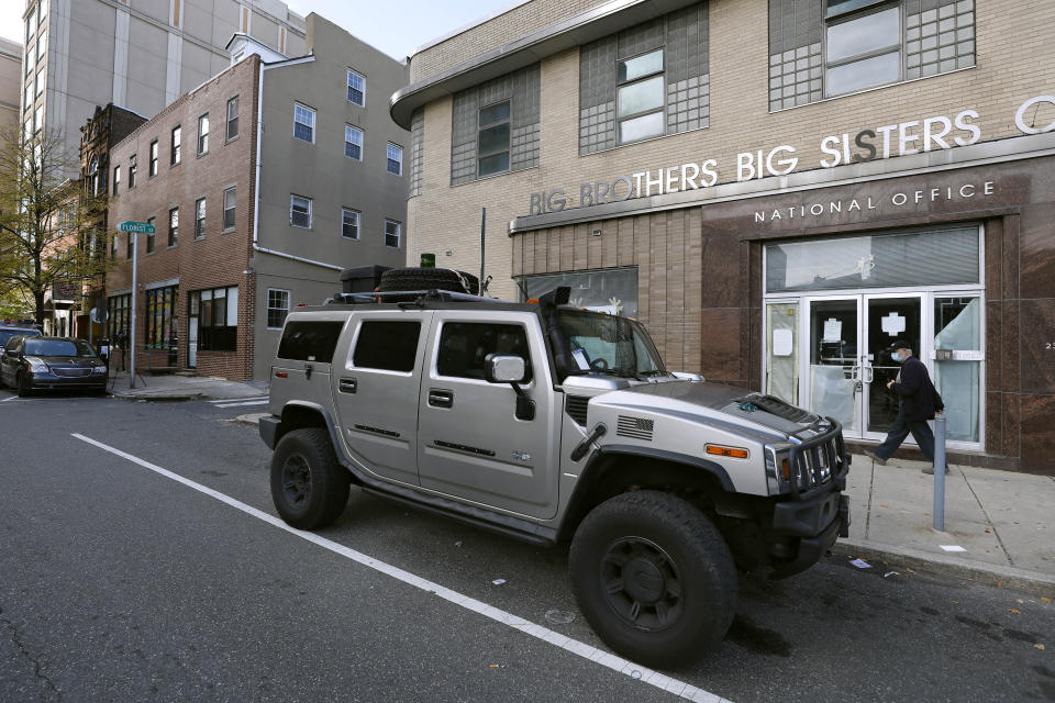 A parking violation envelope is affixed to the windshield of a Hummer vehicle parked near the Pennsylvania Convention Center where votes are being counted, Friday, Nov. 6, 2020, in Philadelphia. Police said Friday they arrested two men Thursday for not having permits to carry firearms near the center. Police said the men acknowledged that the Hummer spotted by officers near the center was was their vehicle. (AP Photo/Rebecca Blackwell)