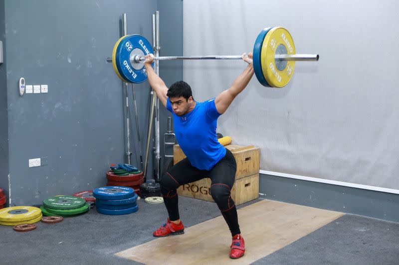 Gaza weight-lifter Mohammad Hamada who is the first Palestinian to compete in the game at the Olympics when it kicks off in Tokyo, practices at a gym in Doha