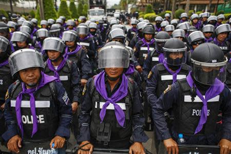 Thai riot police stand guard as anti-government protesters rally inside a compound of the Thai Royal Police Club in Bangkok February 21, 2014. REUTERS/Athit Perawongmetha