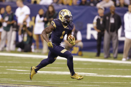 In this Sept. 13, 2014, photo, Notre Dame running back Greg Bryant  runs against Purdue during the first half of an NCAA college football game in Indianapolis. While he is fourth on the team in carries, Bryant leads the eighth-ranked Irish in rushing with 119 yards, averaging 5.4 yards a carry. (AP Photo/Michael Conroy)