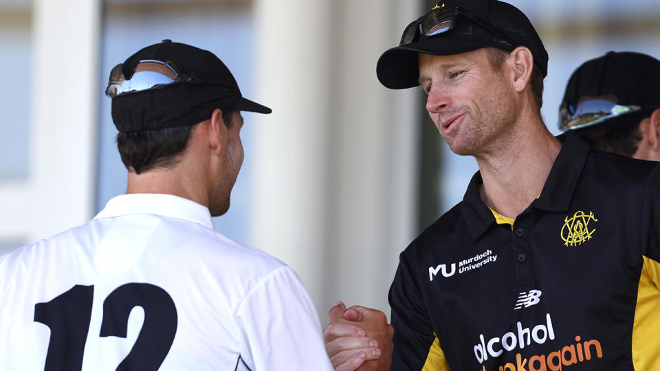 Adam Voges shakes hands with a rival player.