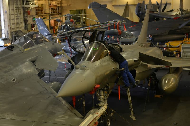 FILE PHOTO: An engineer works on a French Navy Rafale fighter jet, at the hangar bay of the Charles de Gaulle aircraft carrier, currently moored at the port of Limassol